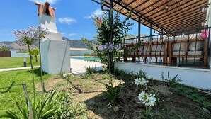 A modern outdoor area with a pool, a pergola, and a stone structure. - VILLA ALTUN 1 (Mugla)