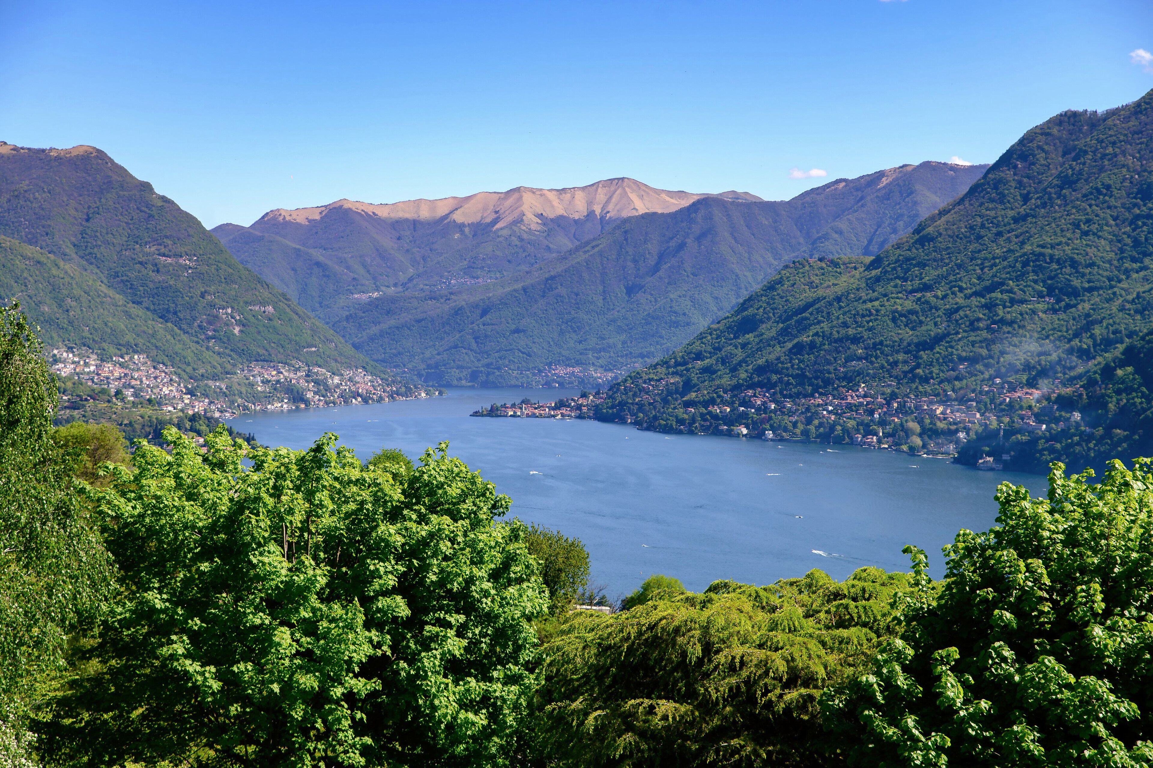A mountainous landscape with a lake and a town nestled in the valley.