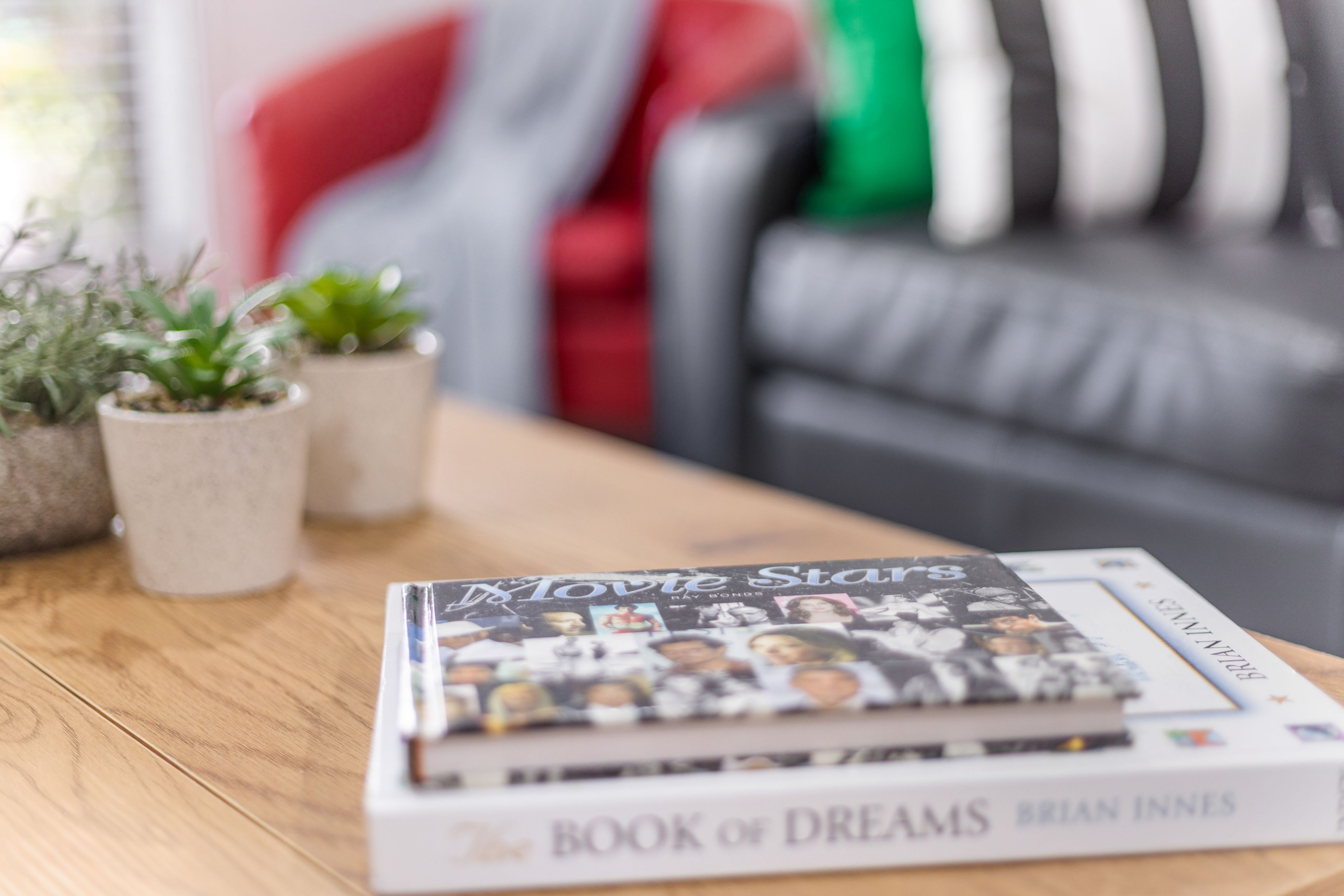 A book titled 'Book of Dreams' by Brian Innes on a wooden table.