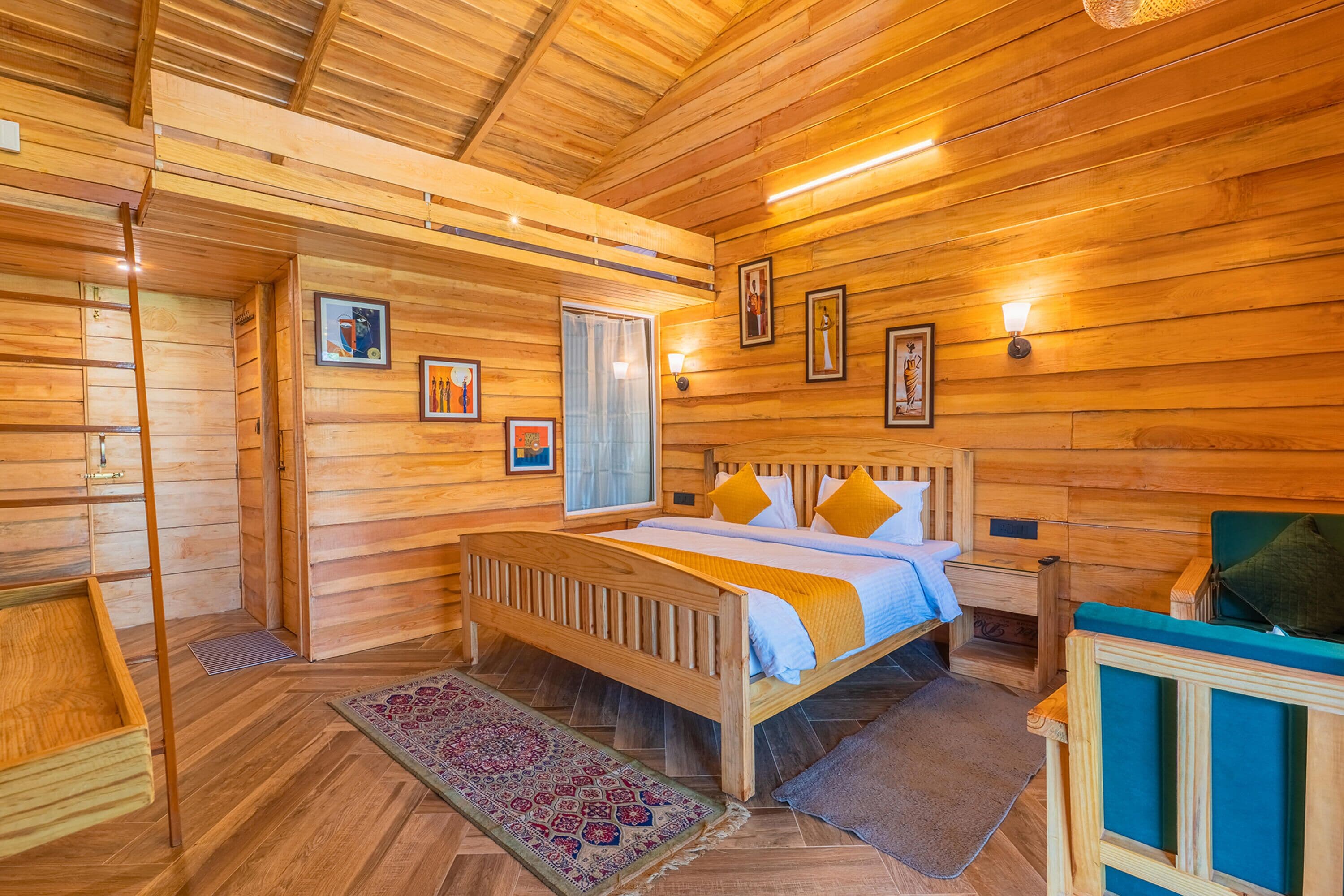A wooden cabin bedroom with a bed, a nightstand, a dresser, a ladder, and a window.