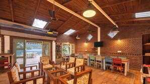 Un intérieur rustique avec des meubles en bois, un mur en briques et une vue sur l’extérieur.