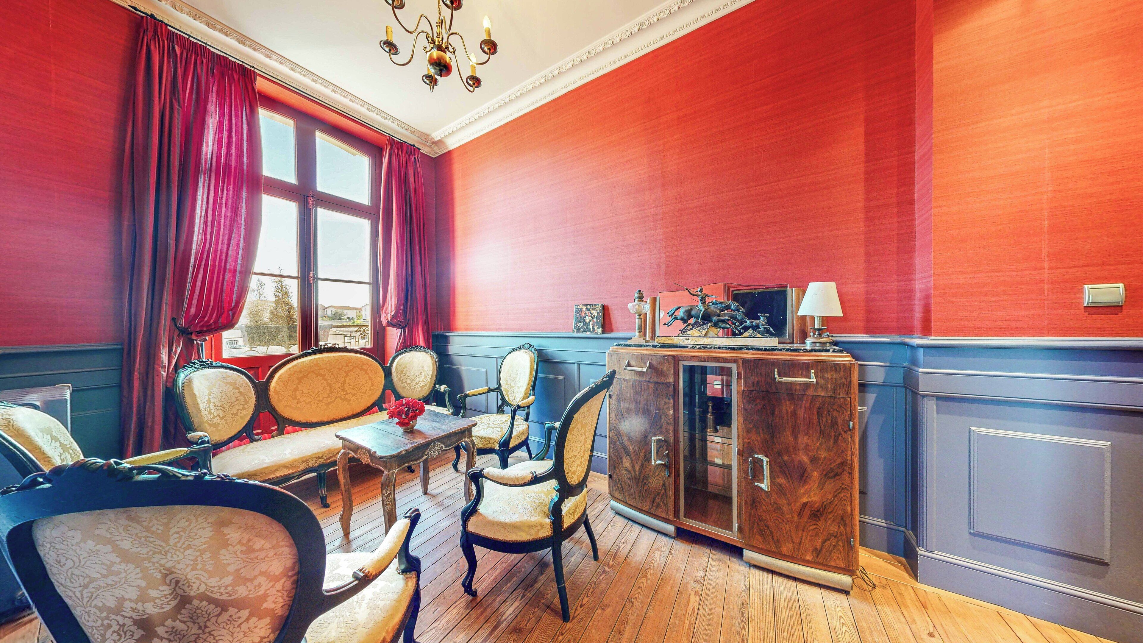 A dining room with a wooden table, four chairs, and a cabinet with a glass door.