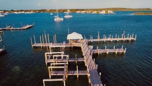 A marina with multiple docks and a white canopy structure.