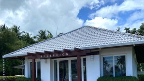 A building with a sign reading "RECEPTION" and a parking area marked "VISITA". - APARTAMENTO VISTA MARE 9-202 (Samana)