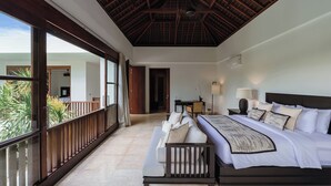 A spacious bedroom with a large bed, a balcony with a wooden railing, and a view of greenery outside. - Luxe Vacay Amara Pradi Chef and Staff included  lvid5 (Seminyak)
