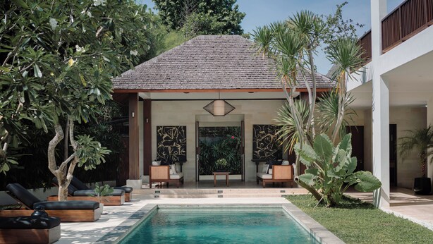 A swimming pool with lounge chairs, a covered seating area, and tropical plants. - Luxe Vacay Amara Pradi Chef and Staff included  lvid5 (Seminyak)