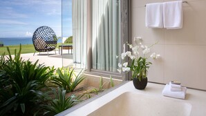 A modern bathroom with a large window, a potted orchid, and a towel rack. - Luxe Vacay Beachfront Sava Villa 4 | Villa Essenza | Chef & Staff | LTH-15 (Takua Thung)