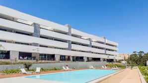 A modern hotel with a large pool, multiple balconies, and a clear blue sky. - Santa Maria II Pool View (SR 1-B2.0O) (Lagos)