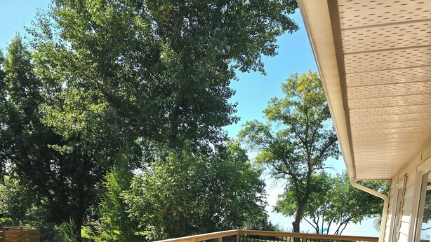 A wooden deck with outdoor furniture, a grill, and potted plants. - BEACHFRONT COTTAGE *fully renovated* (Saint Laurent)