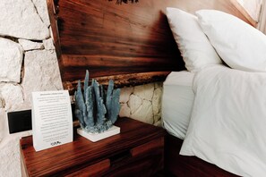 A wooden nightstand with a white pillow and a decorative coral sculpture. - Tulum Jungle Villa Agua (Tulum)