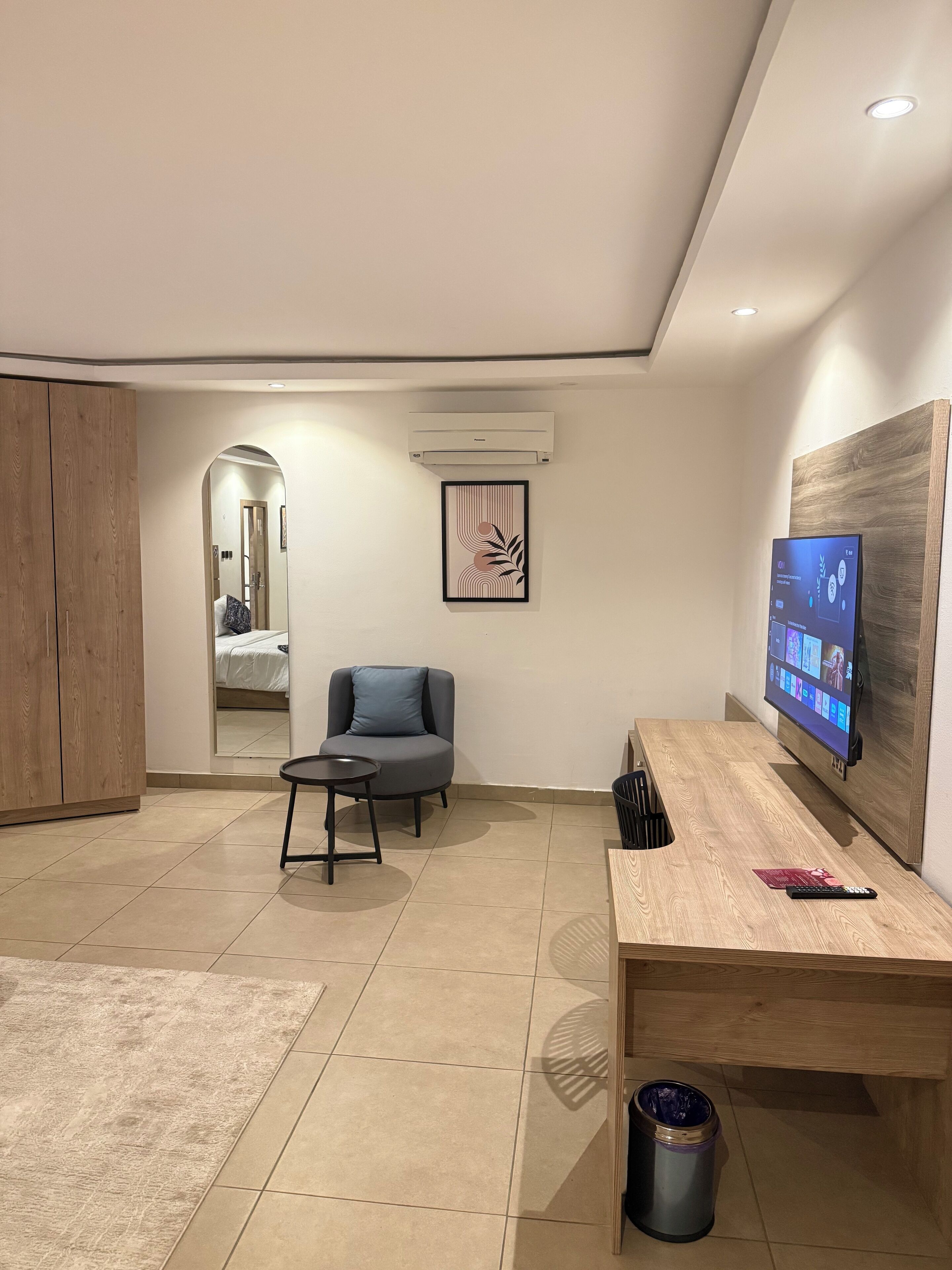 A modern living room with a sofa, a coffee table, a TV, and a wooden cabinet.