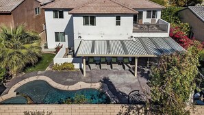 A two-story house with a covered patio and a swimming pool. - Indio Oasis -Pool, Spa, Games & Outdoor Fun (Indio)