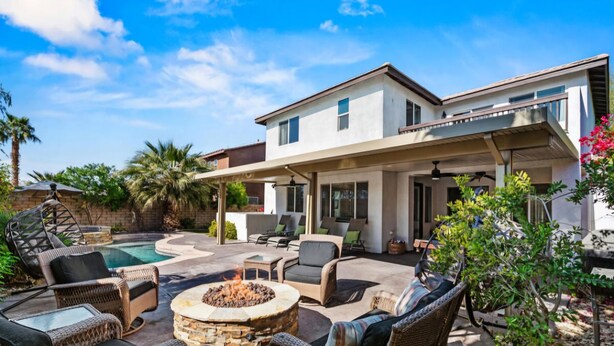 A modern house with a patio area featuring outdoor furniture, a fire pit, and a swimming pool. - Indio Oasis -Pool, Spa, Games & Outdoor Fun (Indio)