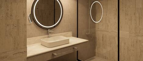 A modern bathroom with a large mirror, a rectangular sink, and a glass shower enclosure.