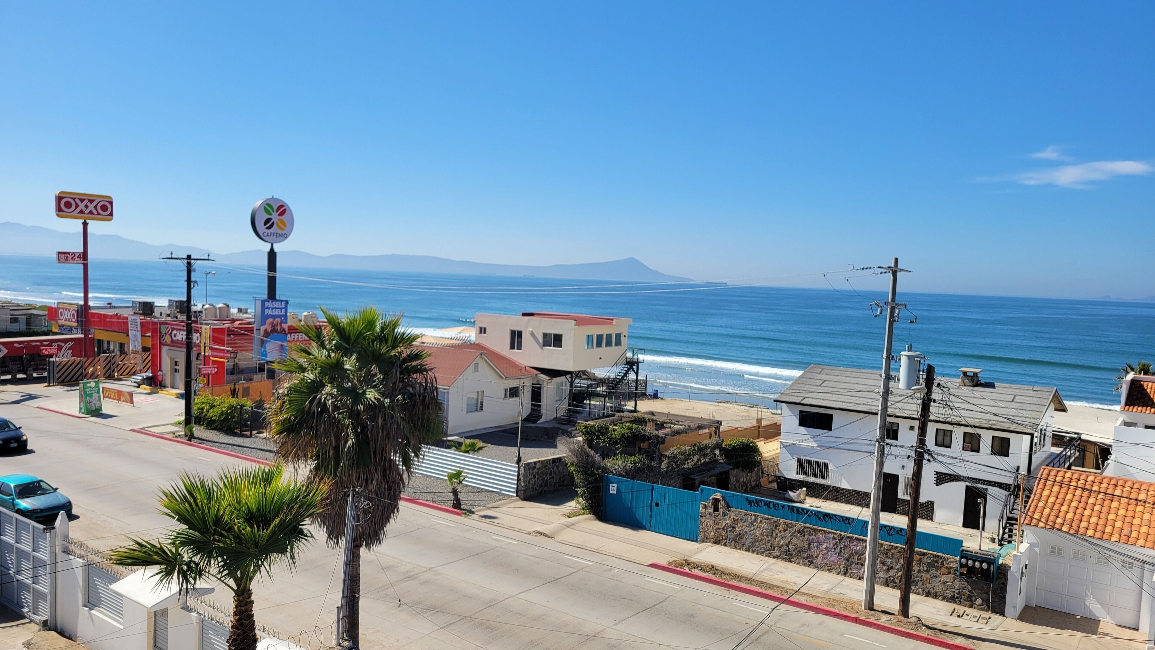A coastal town with a beach, a café, and a gas station.