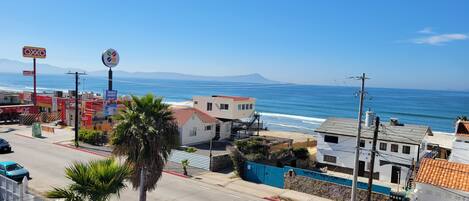 A coastal town with a beach, a café, and a gas station.