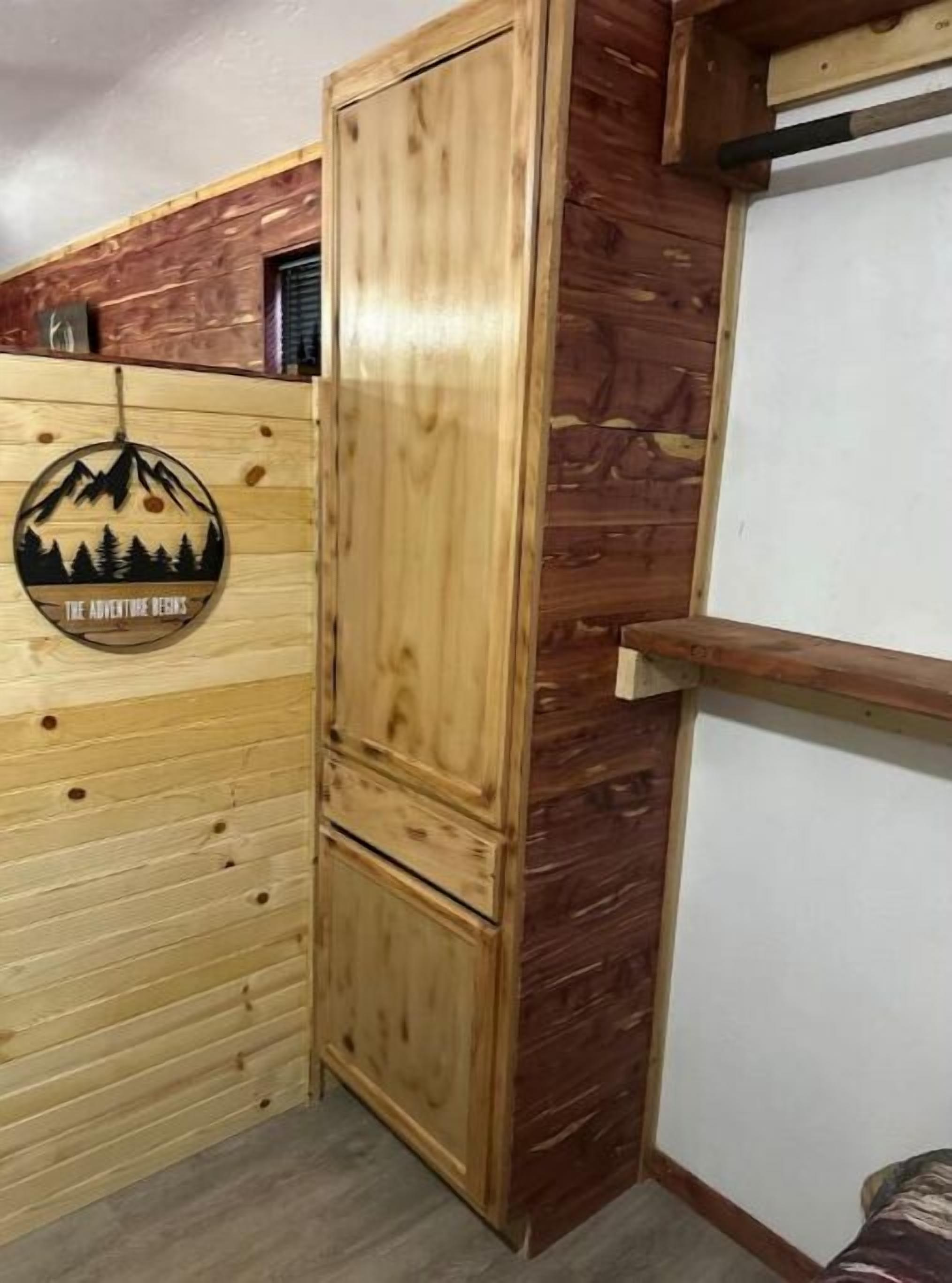 A wooden wardrobe with a circular decoration on the wall.