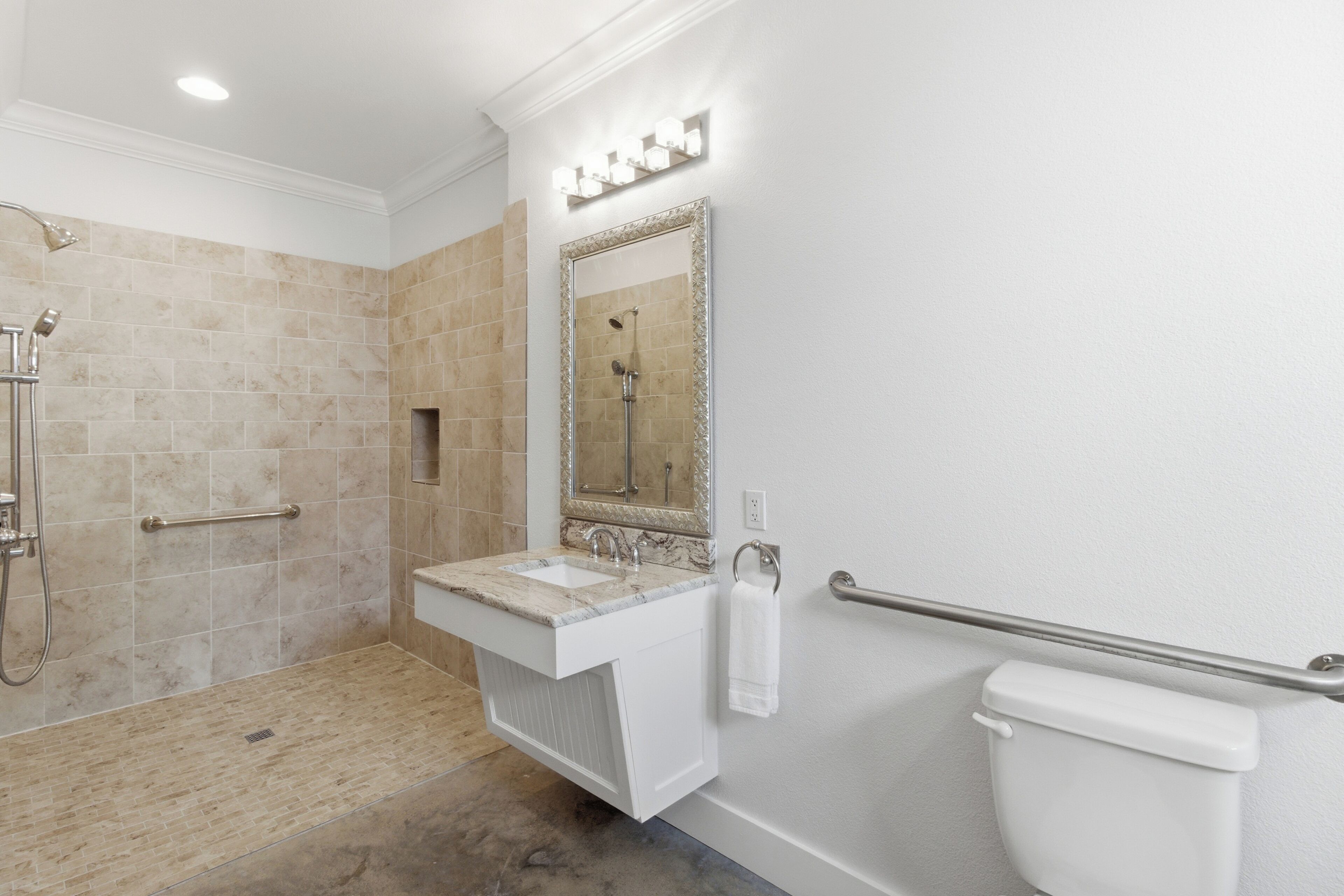 A bathroom with a shower, sink, and toilet.