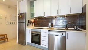 A modern kitchen with stainless steel appliances, a built-in oven, and a dishwasher. - Awesome apartment in San Javier (San Javier)