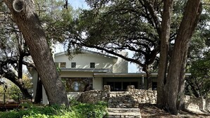 A stone staircase leading to a building surrounded by trees. - Luxury Home on 100 acre Secluded Ranch, Waterfront, Little Frio Creek (Leakey)