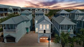 A coastal residential area with multiple two-story houses featuring gabled roofs and front porches. - Sol Shine Gulf-View Retreat Steps from the Sand (Mexico Beach)