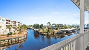 A waterfront hotel with a canal, outdoor pool, and covered areas.