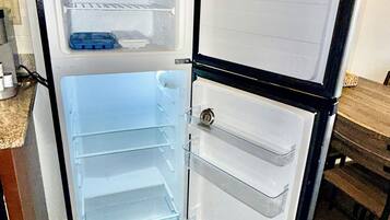 An open refrigerator with two door compartments and a freezer compartment.