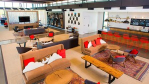 A modern lounge area with sofas, chairs, and a coffee bar. - Cozy Apartment in Austin by The Key Rentals (Austin)