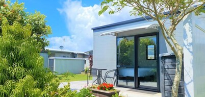 Cozy Matarangi Cabin. Enjoy the gardens and lake views from your private deck.