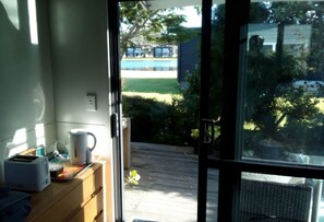 Interior - Cozy Matarangi cabin. Enjoy the gardens and lake views from your private deck. (Matarangi)