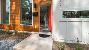 A modern house with large windows, a wooden exterior, and a concrete driveway. - Luxury Modern Comfort in Historic St Augustine (St. Augustine)