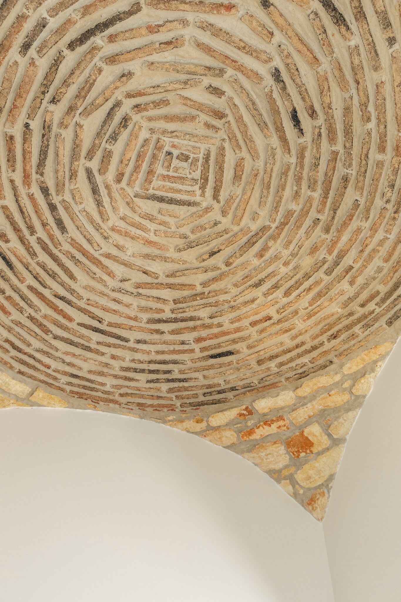 Un motif circulaire en briques au plafond.