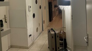 A hallway with a tiled floor, a suitcase, a lamp, and a door leading to another room. - Apartment 85m2 short term rental 1 month 2 months 3 months max available (Bourgoin-Jallieu)