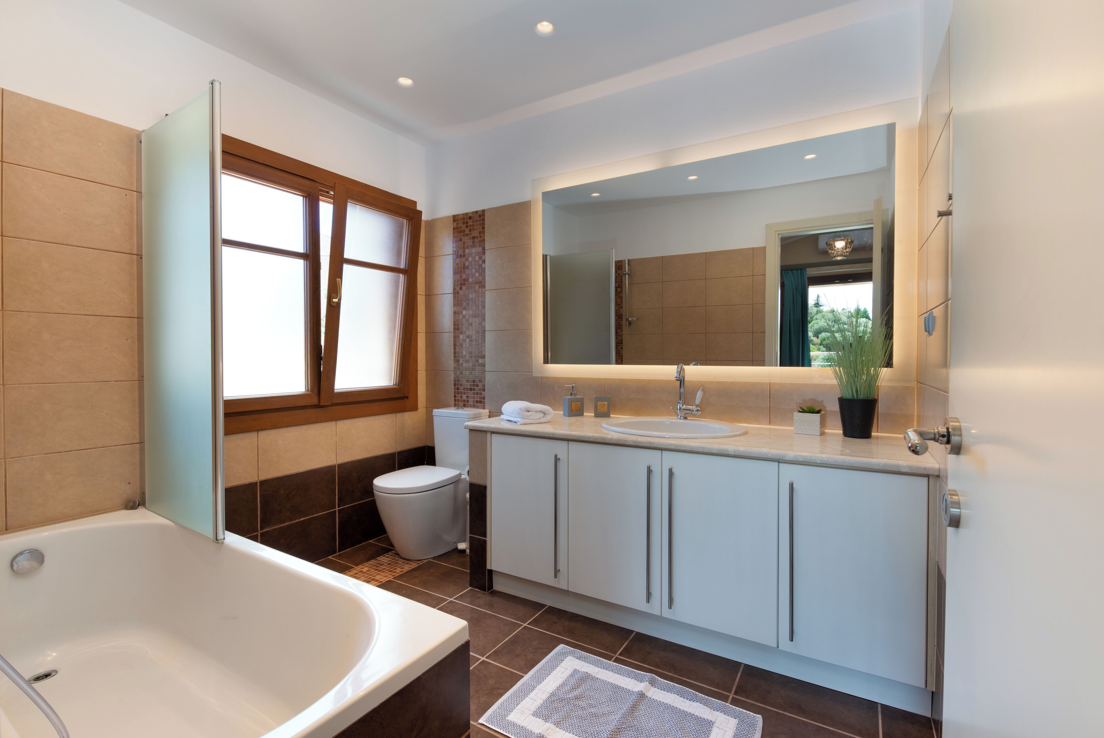 Ein modernes Badezimmer mit einer Badewanne, einem Waschbecken und einer Toilette.