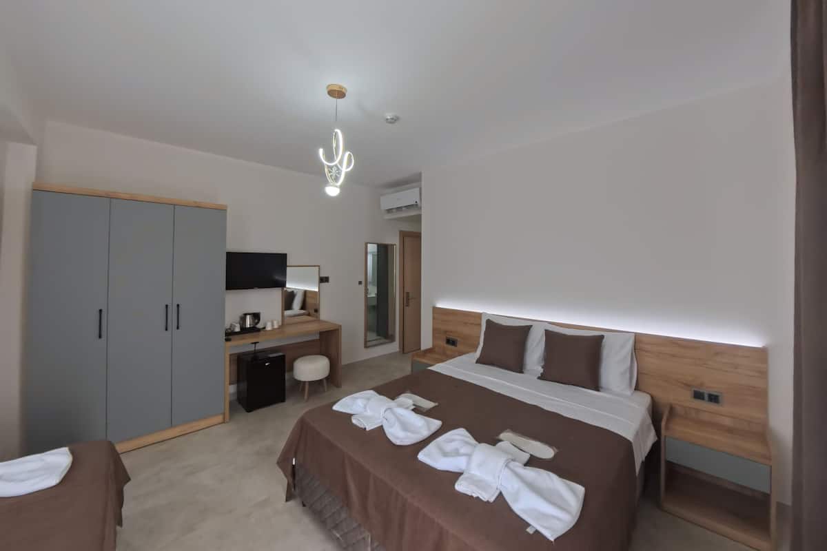 Deluxe Triple Room, Balcony, Pool View | Egyptian cotton sheets, premium bedding, in-room safe, desk