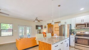 A modern kitchen with white cabinets, stainless steel appliances, and a granite countertop. - < 1 Mi to Lake Rousseau: Waterfront Home! (Inglis)