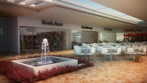 Un espacio interior moderno con una librería, una zona para tomar café y un banco.