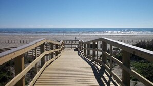 A wooden boardwalk leading to a beach with a clear blue sky. - Condo in Beachfront Community! 4th nt FREE! (Port Aransas)
