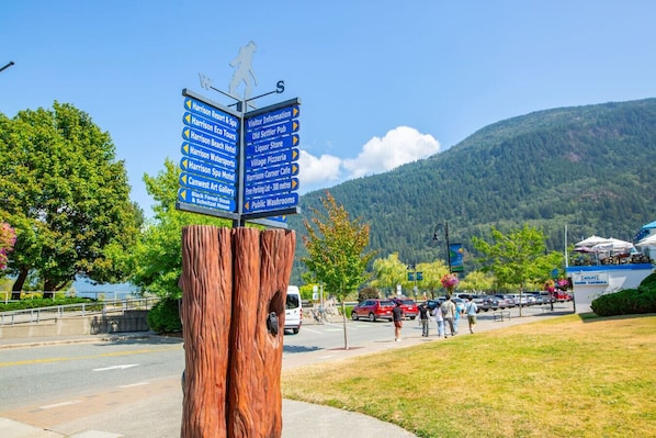 A directional signpost with multiple arrows pointing to various local attractions and amenities.
