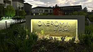 A sign for 'ONEROMA by The Cubes' with a modern building in the background. - One Roma by Cubes (Lusaka)