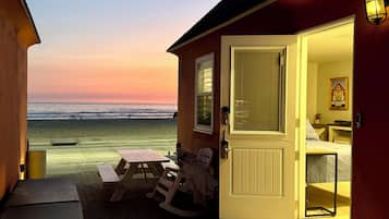 Relax on the porch with a picnic table and rocking chairs, steps from a serene beach.