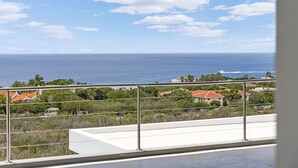 A balcony with a view of the ocean and a residential area. - Kas di Sol Infinito, NEW! Luxury Ocean View Villa w/ Huge Private Pool, 3 Bedrooms & Dive Facilities (Kralendijk)