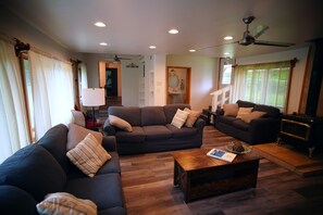 A living room with two sofas, a coffee table, and a fireplace.