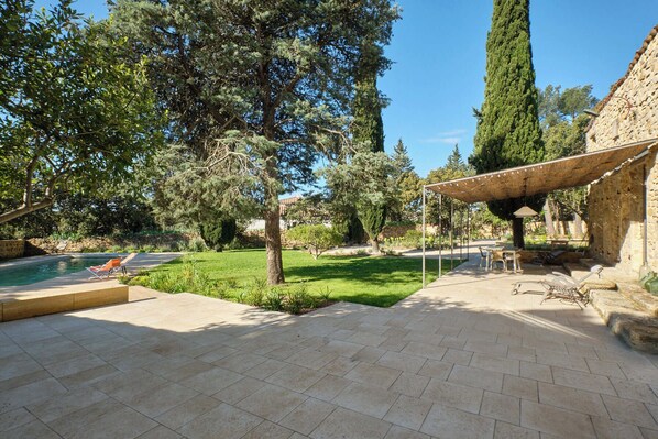 A patio area with a pool, outdoor furniture, and a pergola providing shade. - My family home (Vers-Pont-du-Gard)