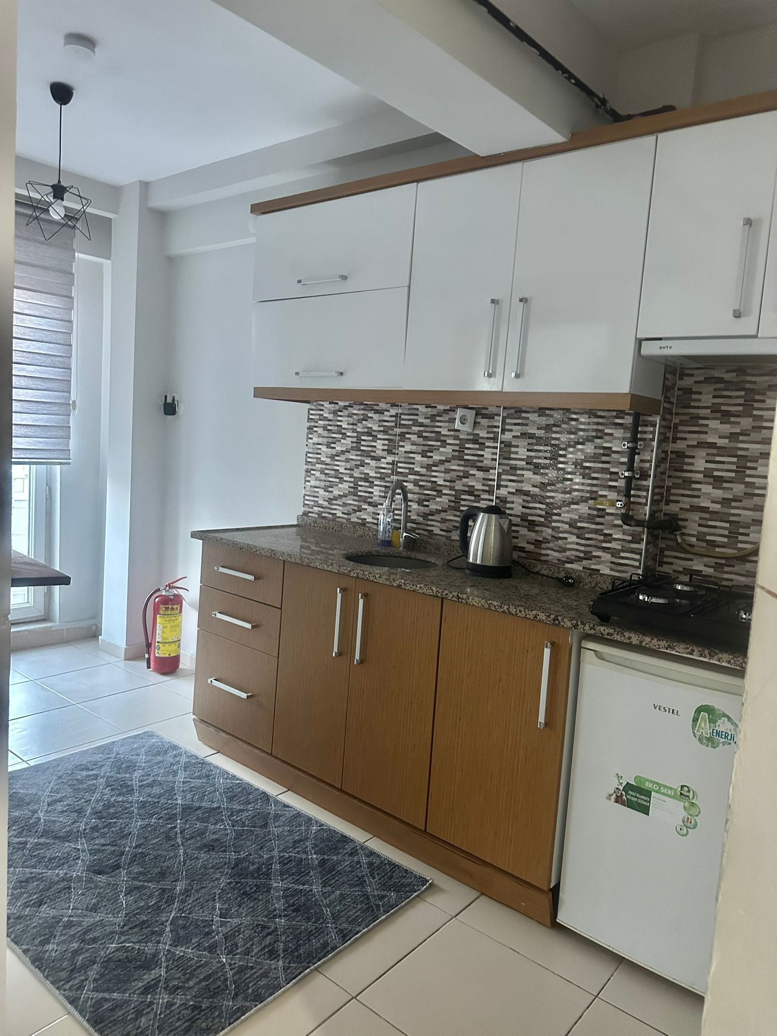 Mini-fridge, stovetop, cookware/dishes/utensils