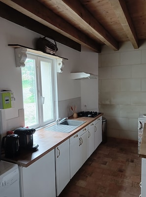 Enjoy cooking in this kitchen with a sink, range hood, and ample cabinetry.
