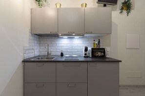 Fridge, microwave, stovetop, coffee/tea maker