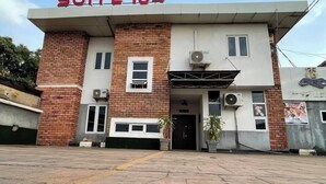 A building with a sign reading "SUITE 104" above the entrance. - suite 104 (Enugu)