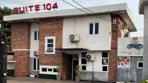 A building with a sign reading "SUITE 104" and a logo for "The G" restaurant. - suite 104 (Enugu)
