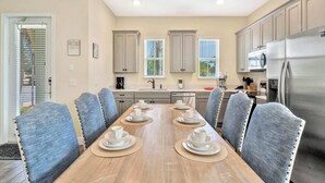 A modern kitchen with a dining area. - It's A Wonderful Life Vacay Home (Kissimmee)